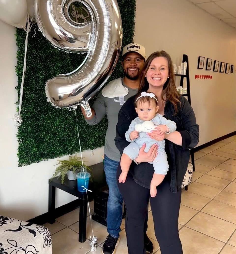 A family celebrating with a number nine balloon inside NutriToledo